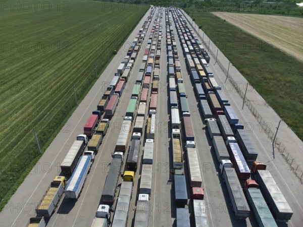 Long queue of trucks in the port at the terminal. Top view of the parking lot waiting for unloading