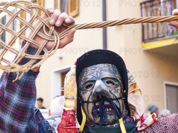 Shignano Italy 21/02/2023: The carnival of Schignano parade is one of the most famous traditional carnivals of north Italy with typical wood masks and performer that entertain the visitors