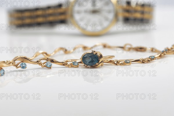 Accessories and jewelry for a fashionable girl : gold ring, necklace and original wristwatch