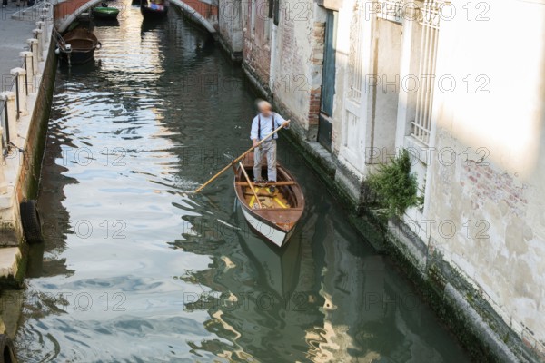 Man on a boat in Venice. Pass thru the channel