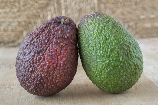 Green and red fruits on a wooden board