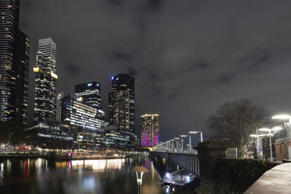 MELBOURNE, AUSTRALIA - JULY 5, 2024: Melbourne skyline as seen at dusk from Sandridge Bridge near Southbank in Melbourne, Victoria, Australia