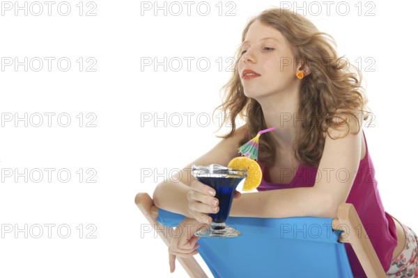 Younb blond woman with luxury cocktail at the beach