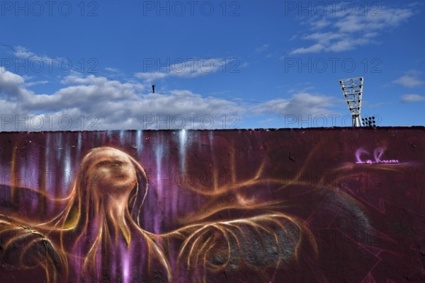 Germany, Berlin, 29.09.2024, Sunday evening in Mauerpark, rope acrobats, floodlight masts Cantian Stadium, ghost, graffiti wall