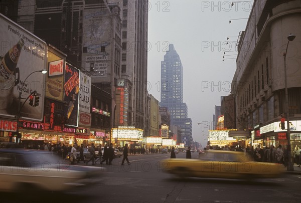 USA New York 1967. Broadway in the evening with cars and people visible and signs on all the buildings. Kodachrome slide original. Credit Roland Palm ref 6-10-20
