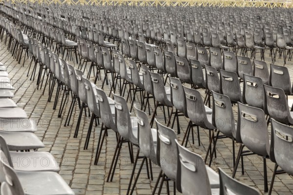 Aligned chairs prepared for an outdoor event