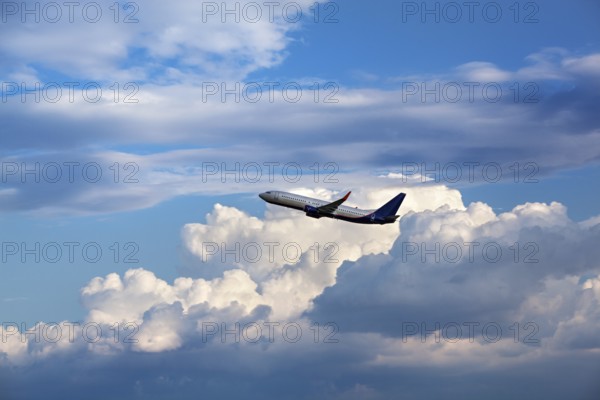 Modern passenger airliner flying in the cloudy sky