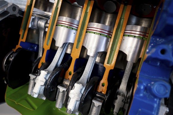 Car engine cut-through view. Four-cylinder straight-four engine piston engine sliced in half