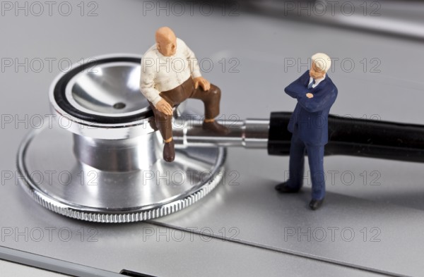 The photo shows two miniature figures in a counselling session