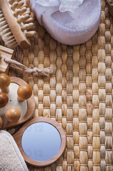 Vanity mirror wooden massagers nail brush and soft bath sponges on wicker background sauna concept