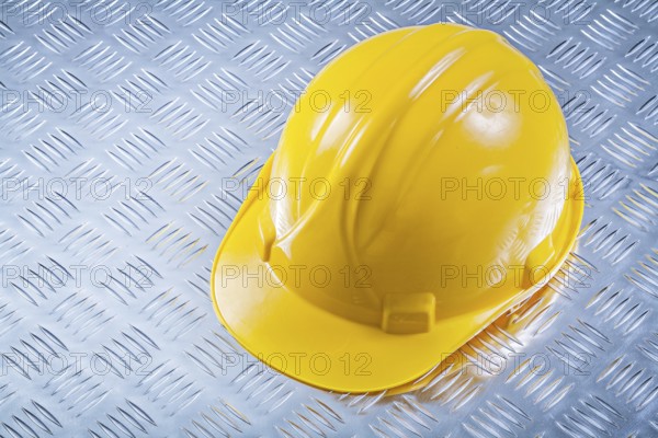 Safety building helmet on grooved metal plate construction concept