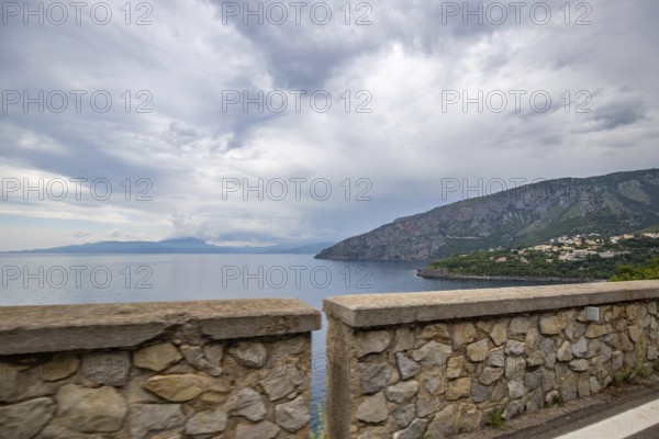 Coastal landscape shot. View from a road leading along the sea and through a breathtaking green Mediterranean landscape. Coast near Salerno, Italy