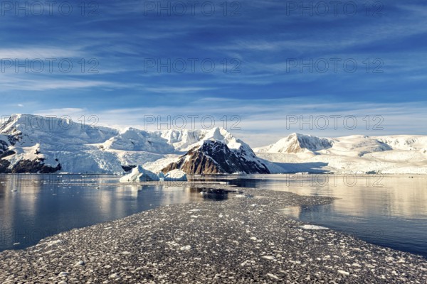 Vast glaciers and icebergs stretch out under a clear, bright blue sky, The landscape of Antarctica
