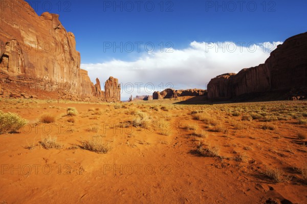Monument Valley is a unique geological formation. The USA. Huge masses of red sandstone - outliers on the Navajo Indian Reservation. The concept of active and photo tourism