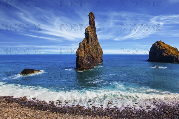 Volcanic island of Madeira in the Atlantic. Impressive trip to a fabulous island in the ocean. Three huge scenic rocks near the pebble beach. Concept of exotic and ecological tourism