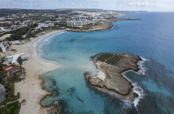 Aerial drone view of the coastline of empty beach in winter. Summer holidays. Nissi beach bay Ayia Napa, Cyprus