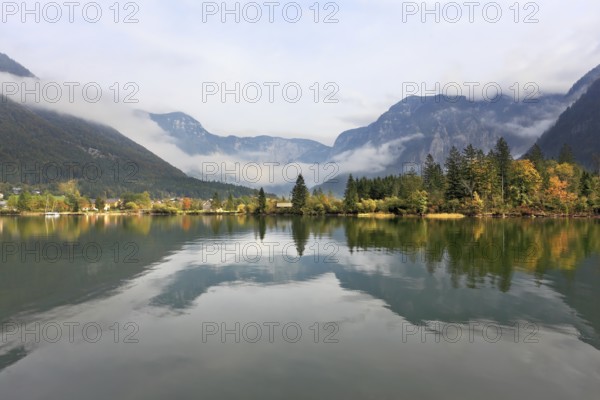 The picturesque shores of Lake Hallstatt. Mountains reflected in the smooth water of the lake