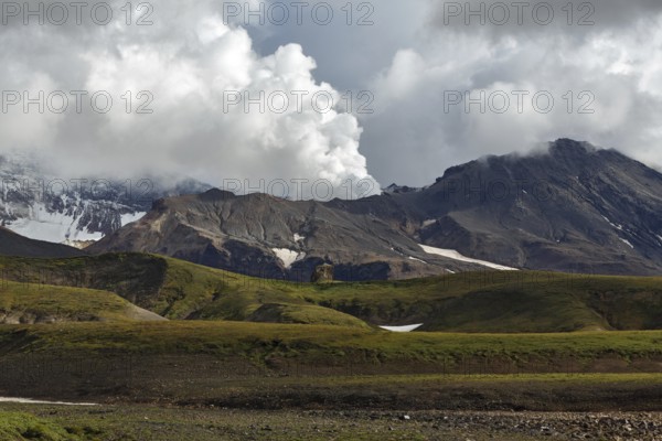 Beautiful volcanic landscape of Kamchatka Peninsula: picturesque view of active Mutnovsky Volcano, fumarolic activity of volcano, steam and gas emissions from crater. Eurasia, Russian Far East, Kamchatka Region