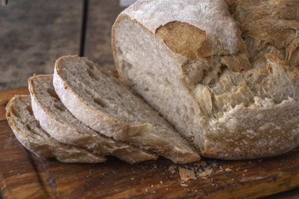 Sliced organic wheat bread and flour on a table.Alsace, France
