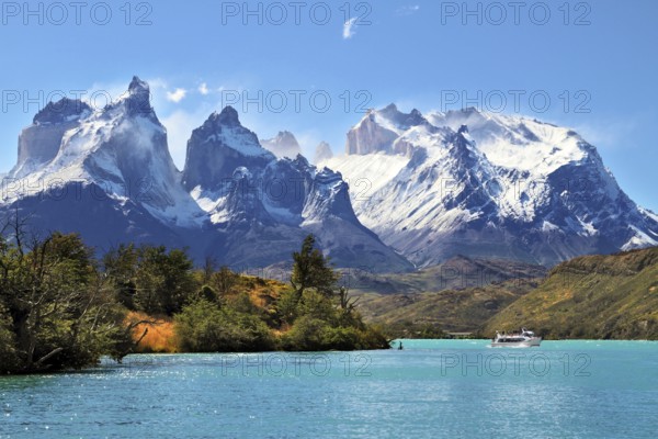 National Park Torres del Paine, Chile. Azure Lake Pehoe at the foot of the magnificent snow-covered cliffs of Los Kuernos
