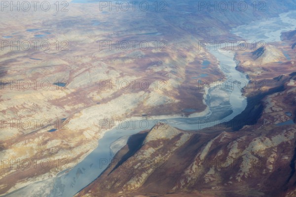 Landscape of Greenland seen from the air in summer with rocky surface, lakes and ground moraine, Greenland