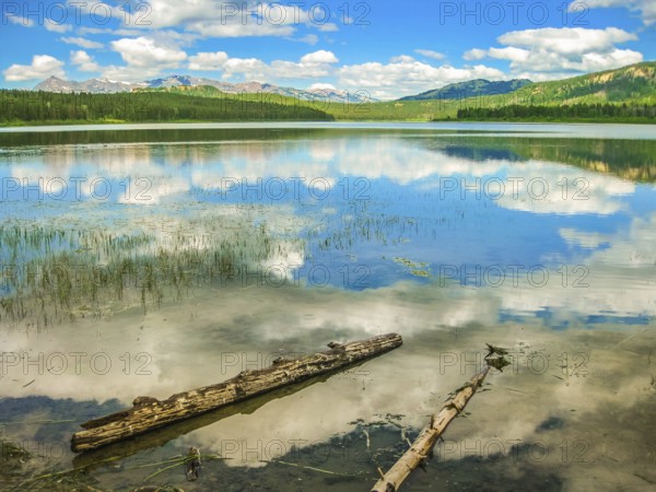 Jackson Lake Overlook at Grand Teton National Park, Wyoming, United States. The beauty clouds reflecting in the calm waters of Jackson Lake. North America travel in summer season
