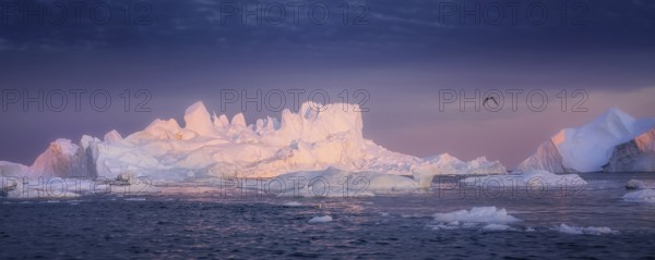 Floating glaciers in the rays of the setting sun at polar night