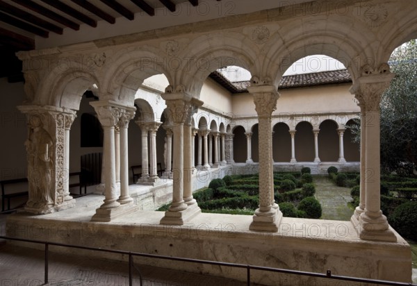 Aix en Provence, cloister of the cathedral. Romanesque cloister partial view left corner pillar with relief of St Peter, St, Saint, Saint
