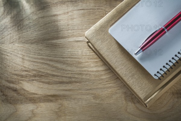 Vintage notepads pen on wooden board