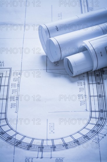 Rolled up construction plans building and architecture concept