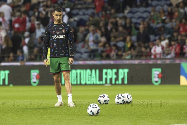 Football match, Cristiano RONALDO CR7 Portugal warming up in front of the match, looking at the ground with his head slightly tilted in front of the shot on goal, Estadio do Dragao, Porto, Portugal
