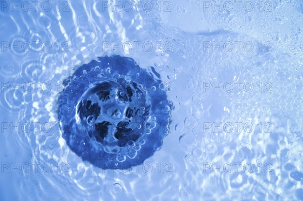 Close-up of bath tub sink with water running away