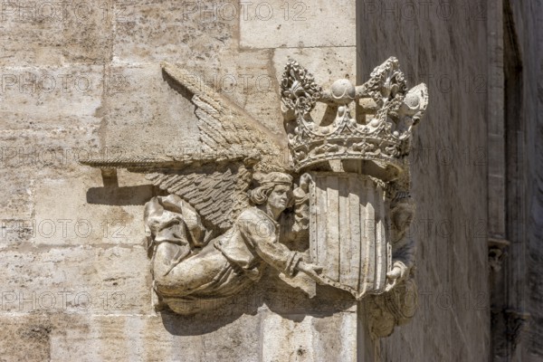Stone sculpture of two angels with the coat of arms and crown of Valencia on the corner of a stone building in the centre of the old town, Valencia, Autonomous Community of Valencia, Province of Valencia, Spain