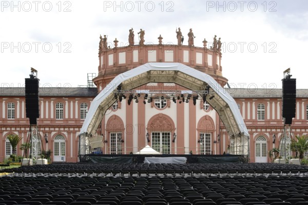 Wiesbaden, Germany - July 14, 2016: A concert stage set up with rows of seats for a classical concert on the palace grounds with Biebrich Palace in the background on 14 July 2016 in Wiesbaden, Germany