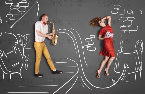 Love story concept of a romantic couple against chalk drawings background. Male playing the saxophone in a restaurant for his girlfriend
