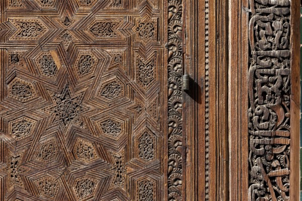 Traditional oriental door detail at the courtyard of madrasa Bou Inaniya in the medina of Fes, Morocco