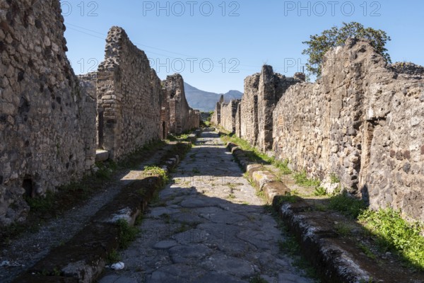 POMPEII, ITALY, MAY 04, 2022, A beautiful typical cobbled street in the ancient city of Pompeii, Southern Italy