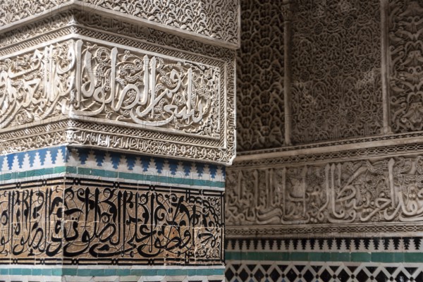 Fes, Morocco, April 04, 2023, Rich decorated facade in the courtyard of the Medersa Attarine in Fes, Morocco