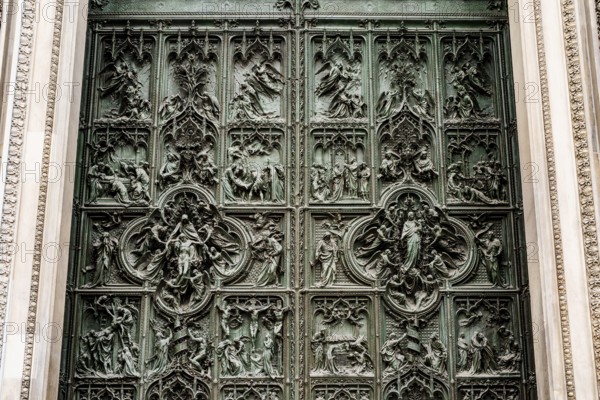 Entrance bronze door to the Duomo. Milan, Italy.