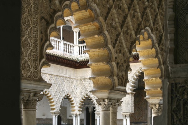 View through an archway into the inner courtyard of the Alcazar in Seville
