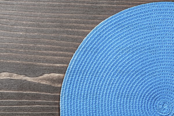 Blue wicker table matting on wooden board