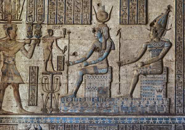 Hieroglyphic carvings on the exterior walls of an ancient egyptian temple