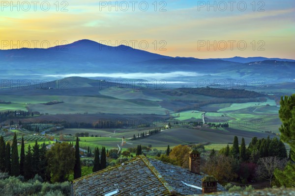 Predawn dusk. Tuscany. Photo taken on a protective wall around the ancient city of Pienza. The concept of active and photo tourism