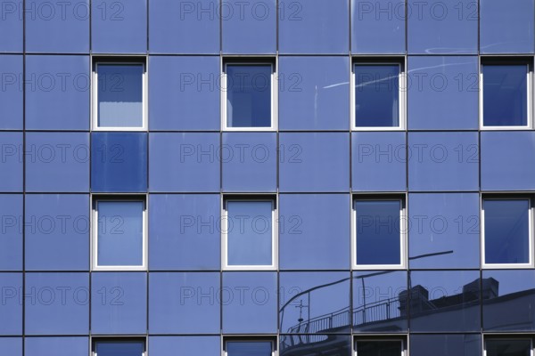 The reflection of buildings in the modern mirror façade of an office and residential building