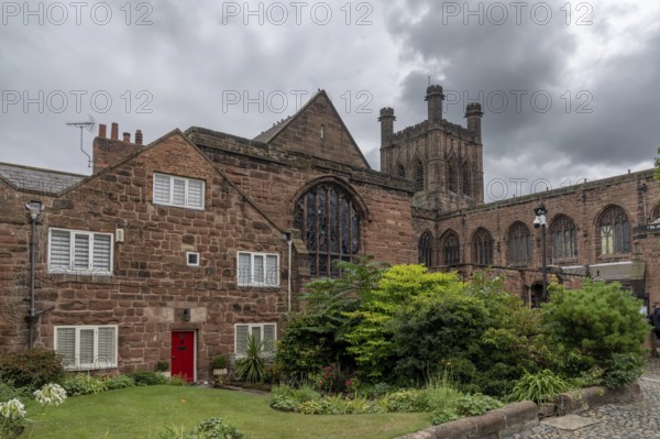 Chester, United Kingdom, 26 August, 2022: downtown Chester in Cheshire with its historic red brick buildings and the 12th-century cathedral in the background under an overcast sky