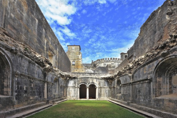 Palace of the Knights Templar in the small town of Tomar, Portugal. Beautiful green inner courtyard, surrounded by a fine building with a beautifully preserved architecture