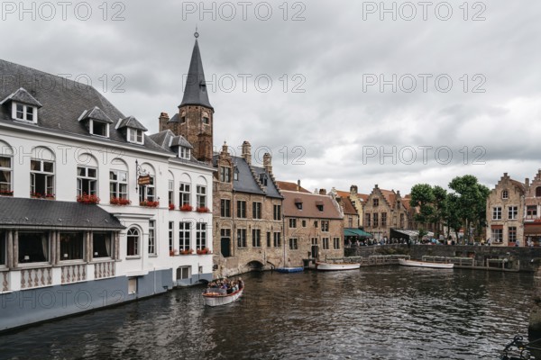 Bruges, Belgium, July 29, 2016: Canal scene in the city of Bruges. The historic city centre is a World Heritage Site of UNESCO. It is known for his picturesque cobbled lanes and dreamy canals