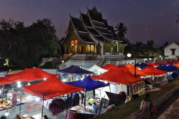 Night market in front of the Buddhist temple Haw Phra Bang of the Royal Palace, National Museum on Sisavangvong Road, Luang Prabang, Laos