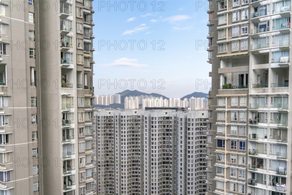 The view of residential neighborhood and skyscrapers from rooftop in Hong Kong