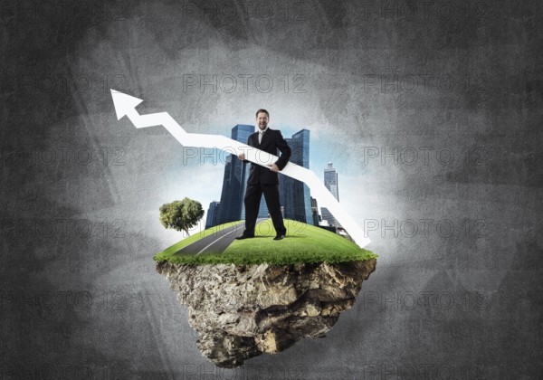 Conceptual image of young and confident business man in suit holding big white arrow in hands